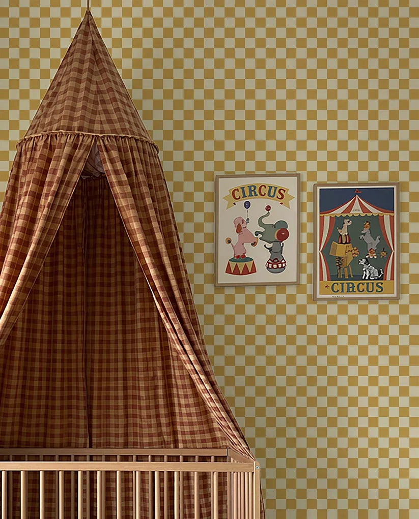 Checkerboard Ochre Yellow – Atelier Chien: wallpaper next to a crib with a canopy.