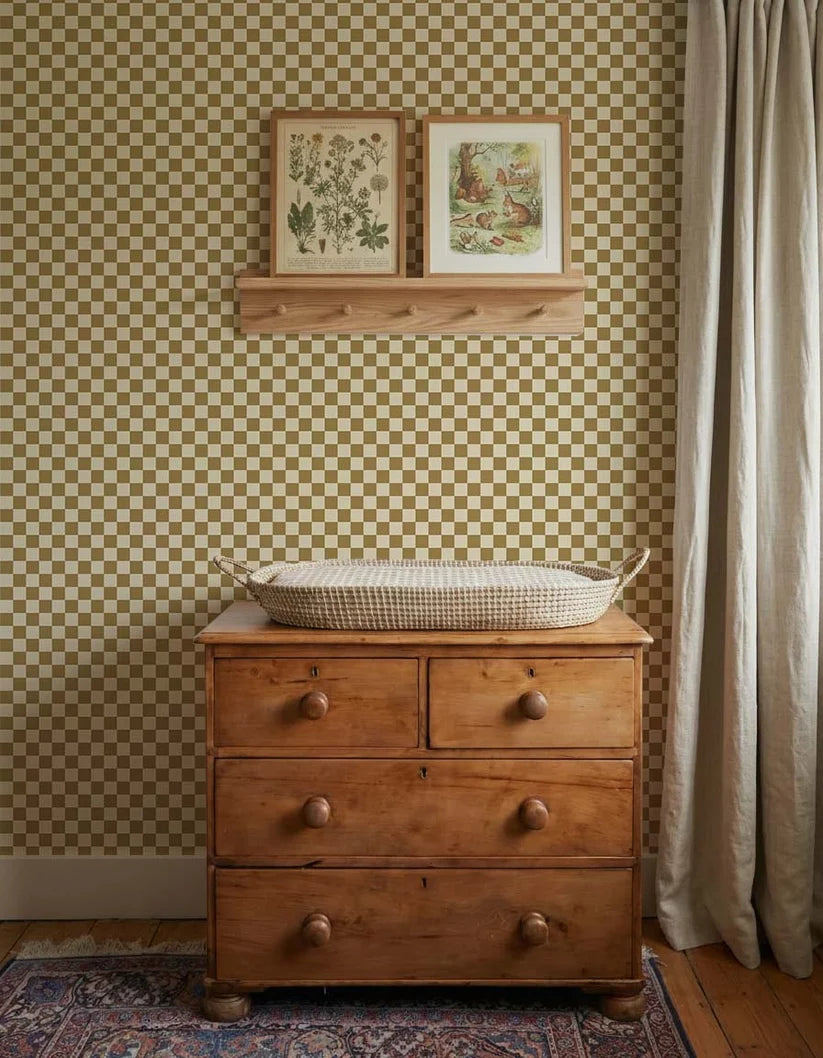 Dambord Olijfgroen – Atelier Chien: wallpaper behind a wooden changing table with a changing basket.
