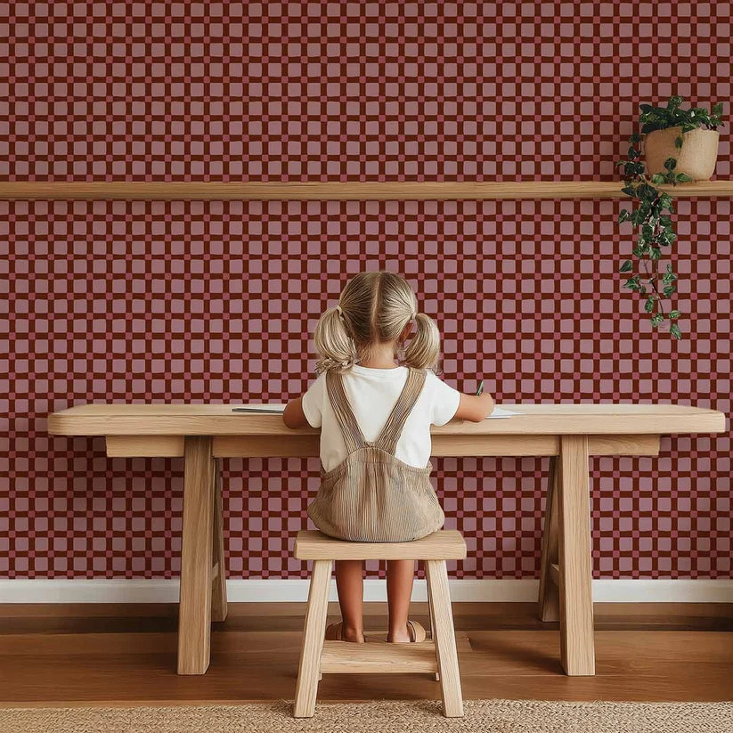Quilt Check Bordeaux Red – Atelier Chien: wallpaper behind a child at a wooden table.